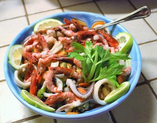 evocative image of fish salad with parsley and lemon