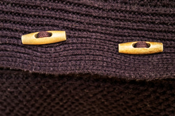 Abstract concept. Buttons on a vintage knitted sweater look like eyes.
