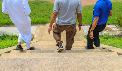 Fototapeta premium Walk men in the stairs, Businessman going down the stairs