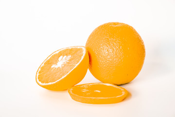 Sliced orange with green leaf isolated on white background