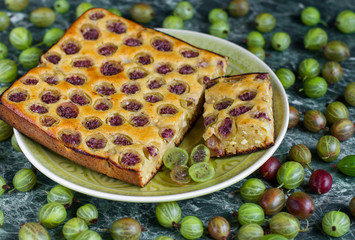 sliced ​​homemade pie with gooseberries on plate
