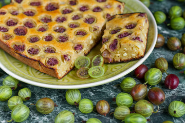 sliced ​​homemade pie with gooseberries on plate