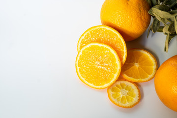 Sliced orange with green leaf isolated on white background