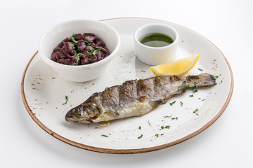Grilled whole fish with red bean, lemon and soy sauce isolated on white background