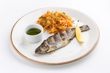 Grilled whole fish with cabbage stew, lemon and soy sauce isolated on white background