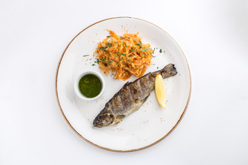 Grilled whole fish with cabbage stew, lemon and soy sauce isolated on white background