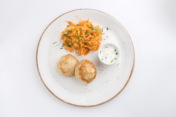 meat balls and cabbage stew with white sauce isolated on white background