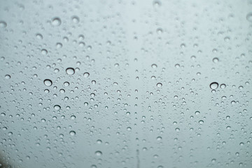 Close up Drops of water on the glass in the rainy season