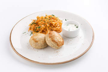 meat balls and cabbage stew with white sauce isolated on white background