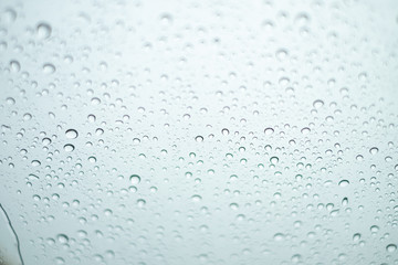 Close up Drops of water on the glass in the rainy season