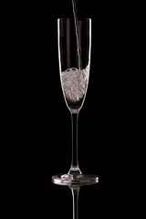 Glass of champagne on a black background