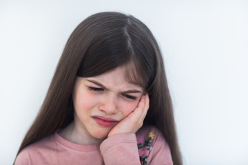 Beautiful little  sad girl with a toothache