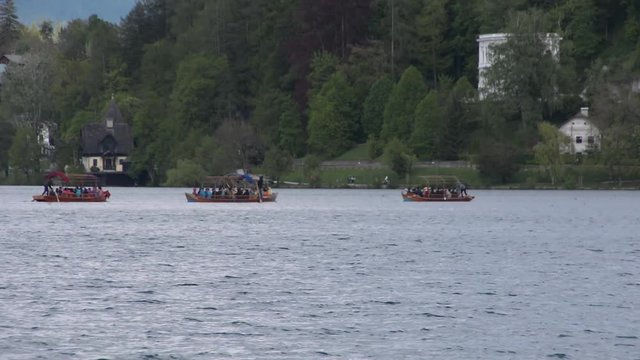 Traditional pletna boat on lake Bled goes to island