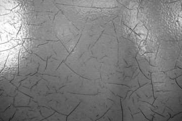 Cracked paint texture in black and white.