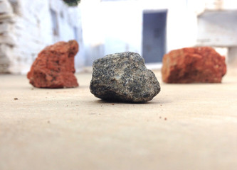 one black and two red stone put on the road