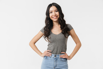 Excited happy young woman posing isolated over white wall background.