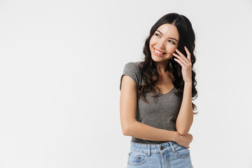 Excited happy young woman posing isolated over white wall background.