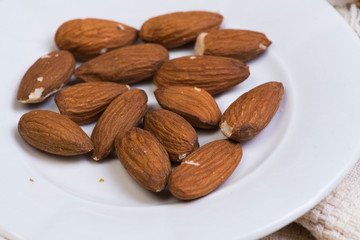 almonds in bowl isolated on white background