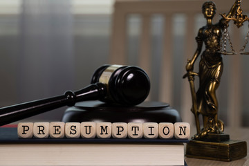 Word PRESUMPTION composed of wooden dices. Wooden gavel and statue of Themis in the background.