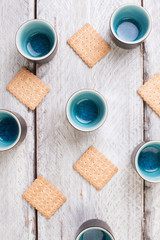 Fototapeta na wymiar tea cups and cookies on white wooden table