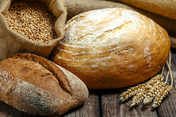 loaf of bread on wooden background, food closeup.Fresh homemade bread.French bread. Bread at leaven. Unleavened bread.Ciabatta bread.