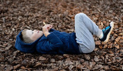 environmentally friendly coatings for playgrounds. a little boy is having fun playing on the modern urban European playground