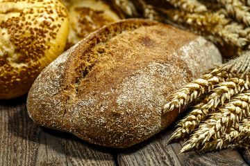 loaf of bread on wooden background, food closeup.Fresh homemade bread.French bread. Bread at...