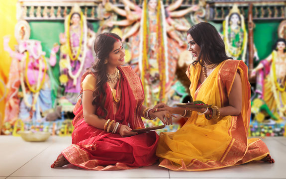 Two bengali Married women doing prepartion for Durga Puja