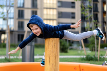 a little boy is having fun playing on the modern urban European playground