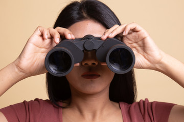 Young Asian woman with binoculars.