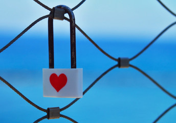 Love lock in front of blue sea