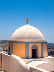 Fototapeta na wymiar The dome of the baroque Roman Catholic Church of St John the Baptist in Fire Santorini. The church was built in 1823 and was completely restored and rebuilt in 1970, after the earthquake of 1956. 