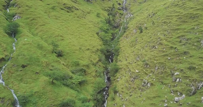 Colorful 4K Video of falling water among emerald greens of wild Irish nature in Kerry mountains.