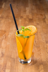 Orange drink on wooden background. For fast food restaurant design or fast food menu