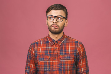 Expression and people concept - man with funny face isolated over pink background. Funny handsome hipster.