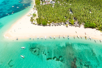 Fototapeta na wymiar Beautiful tropical island in sunny weather, view from above. Daco island, Philippines. White sandy beach and turquoise lagoon.