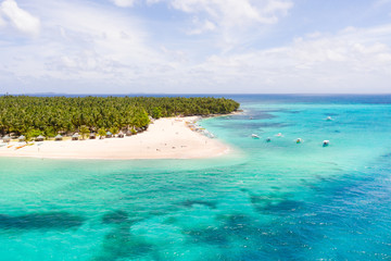 Seascape with a beautiful island. Daco island, Philippines. Tropical island with a white sandy beach for tourists. Island to relax.