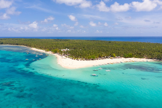 Seascape with a beautiful island. Daco island, Philippines. Tropical island with a white sandy beach for tourists. Island to relax.