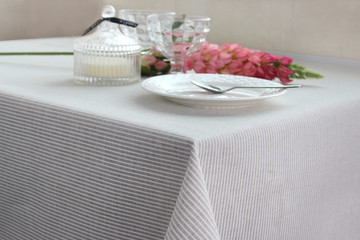 plates are on the table, a table with a gray tablecloth, a served table
