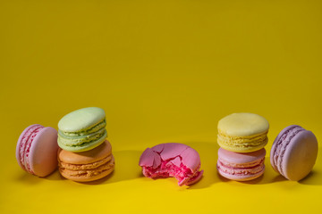 Green pink orange yellow macaroni laid out horizontally, Festive confectionery, sweet cookies, confectionery