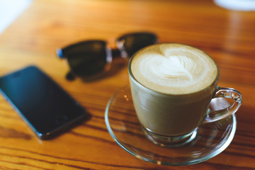 Coffee cup Capucino with bakery Served on wooden table.