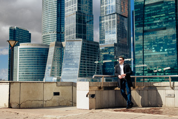 stylish young male businessman on the background of the cityscape