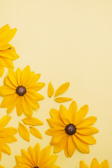 Flowers composition. Pattern made of yellow flowers on pastel yellow background. Summer and autumn concept. Flat lay, top view, copy space