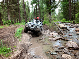 Off-road vehicle goes on the mountain way, Altai