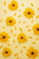 Flowers composition. Pattern made of yellow flowers on yellow background. Summer and autumn concept. Flat lay, top view, copy space