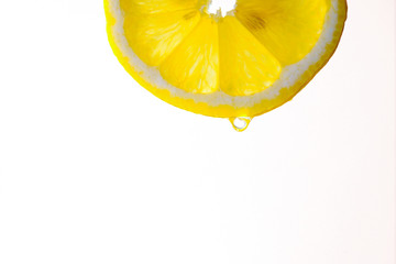 a juicy slice of lemon with juice on a white background 