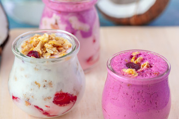 healthy products for breakfast, granola and fresh berries on white table