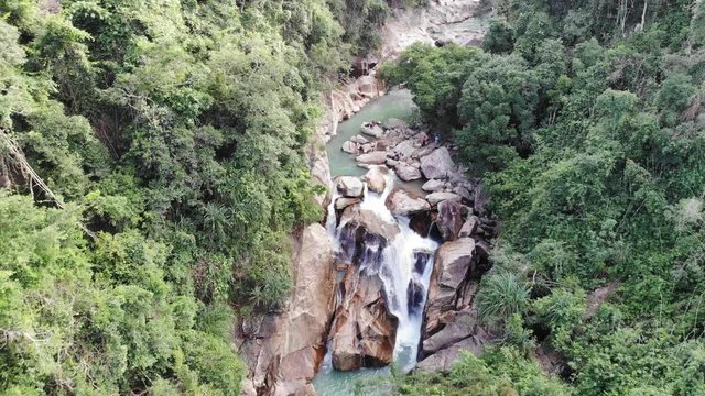Small Cascade Waterfall in the Tropical Forest and Narrow Mountain Rocky River Aerial View
