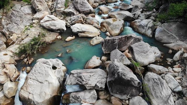 Beautiful Narrow Mountain River with Large Stones and Cascades with Clear Water. Aerial View