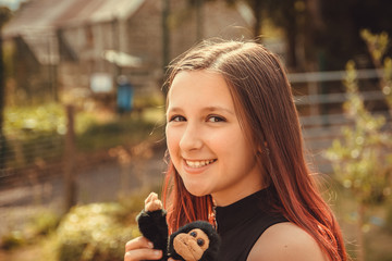 Young dark haired girl relaxing outdoors